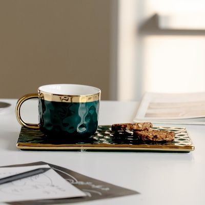 Mugs élégantes en céramique noire avec des accents dorés et des textures ondulées, pour le café, le thé et les pâtisseries. Design moderne et minimaliste.